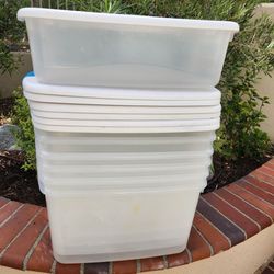 Seven Sterilite storage containers with lids