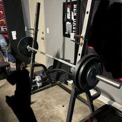 SQUAT RACK / BENCH PRESS / PULLY SYSTEM.  WITH 240 LBS OF WEIGHTS 