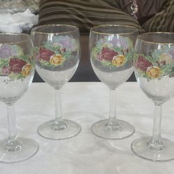 Set of four Royal Albert Old Country Roses wine glasses with gold trim.