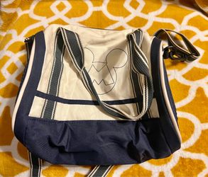 Disney Baby by Zara canvas tote with navy blue base and cream panels. Striped shoulder handles and adjustable crossbody strap. Front line-art Mickey g
