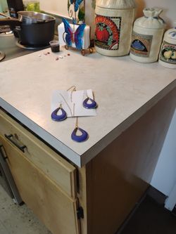 Women's black and blue navy blue necklace with gold trim and navy blue earrings with matching gold trim