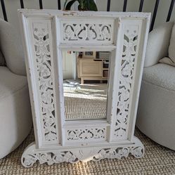 Intricately carved white wood sacred mirror