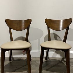 TWO solid wood wingback side chairs in modern mid century style. 31.5” H x 21.75” D x 17.25” W. MSRP $205. Our price $115 + sales tax