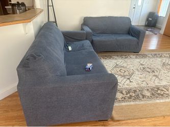 Dark grey couches with dark blue covers