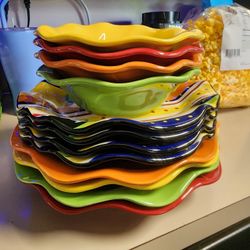 Set of whimsical dishes,  plates and bowls 
Stoneware 
Colorful 
Dishwasher and microwave safe