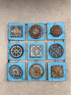 patina metal wall art piece, often featured in rustic or farmhouse decor
