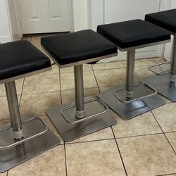 4 Contemporary Adjustable Bar Stools With Black Faux Leather Seats & Brush Stainless Steel Base 