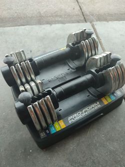 Adjustable dumbbells with a Pro-Form Fusion SpaceSaver 25 base.