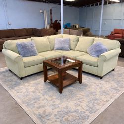 Very Comfy Green Sectional Sofa with a wooden coffee table. (Delivery available, see details)