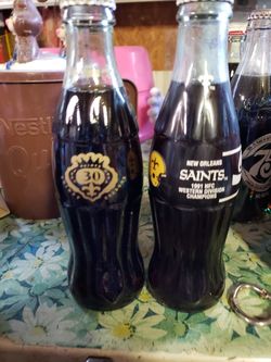 2 New Orleans saints Coca-Cola bottles