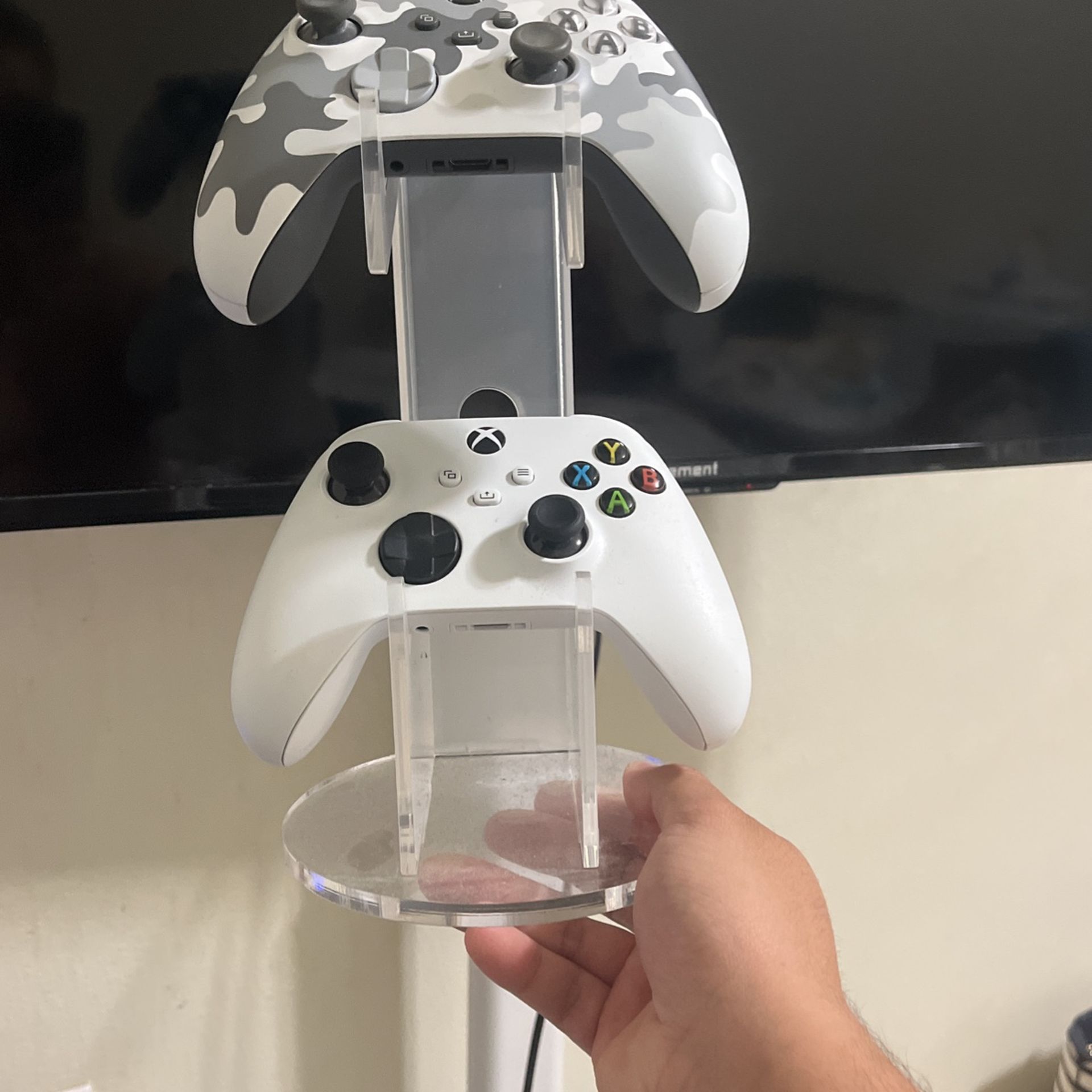 Two Xbox Controllers With A Desk Stand
