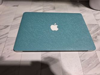 TEAL MacBook Air 13-inch, 2015 model with Intel Core i5, 8GB RAM, and 128GB SSD. Silver aluminum body with a full keyboard and trackpad. Powers on and