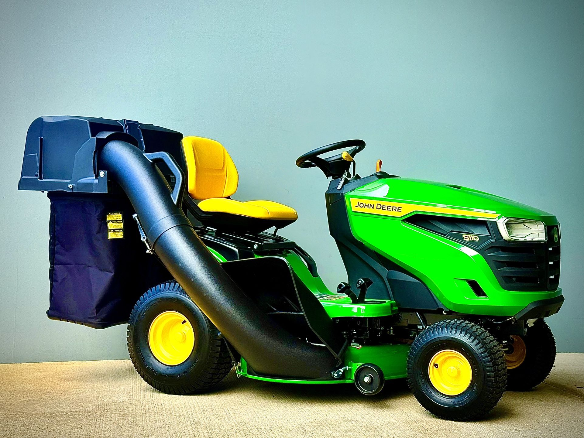 Brand new John Deere S110 42-in 19 - HP Single cylinder Gas Riding lawn mower comes with John Deere Bagger.