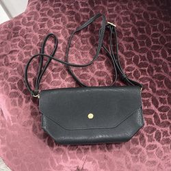 Black, leather envelope cross body/ wristlet bag with gold tone. See pictures .