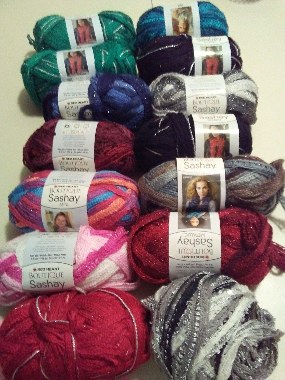 Red Heart Sashay, Premier Starbella, Willow Aura and chenille ruffled scarf yarn.
