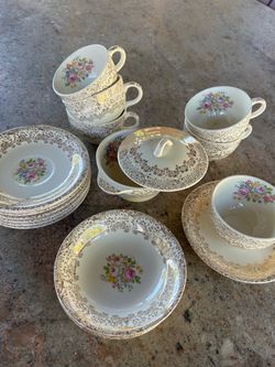 Vintage porcelain tea set in the Rose Glory pattern by Royal China Sebring. This collection features a white base with floral motifs and intricate 22-