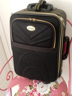Black rolling luggage brass trim