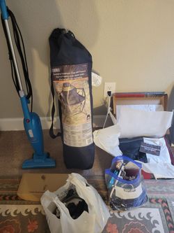 Camping chair, New Wolverine work boots size 8.5, Mini vacuum with replacement filters, and 2 bags full of random things