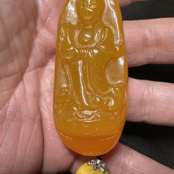 Guanyin Bodhisattva pendant, carved from yellow amber has a warm honey-yellow color