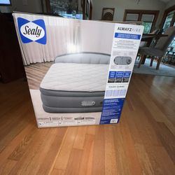 Brand new in the box Sealy Alwayzaire queen Air mattress. Tough guard, quilted topper Tested good Fits up to two adults USB port for phone or tablet c