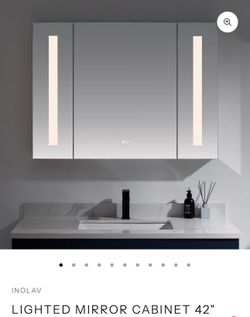 Modern lighted mirror cabinet with integrated lighting.