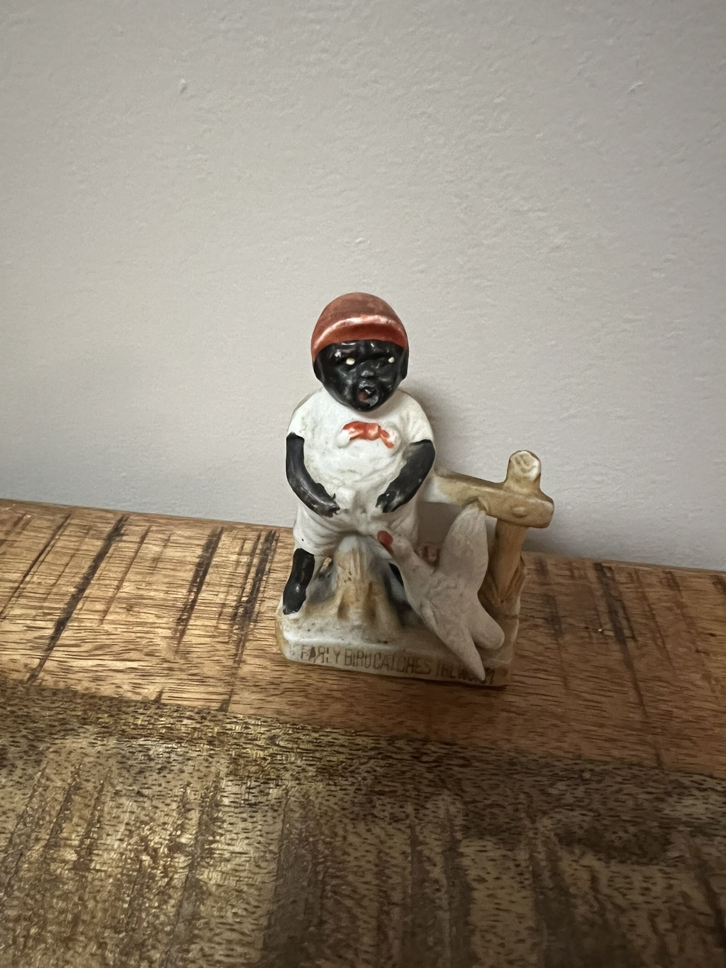 Bisque Porcelain 1940s porcelain figurine featuring African American boy with a white bird