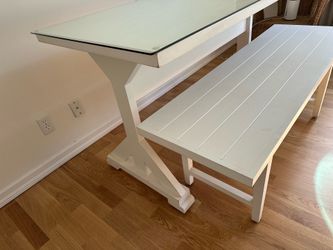 White farm table with glass top and 2 benches.