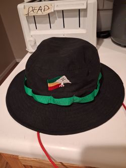 Black and green LRG bucket hat with red adjustable chin strap