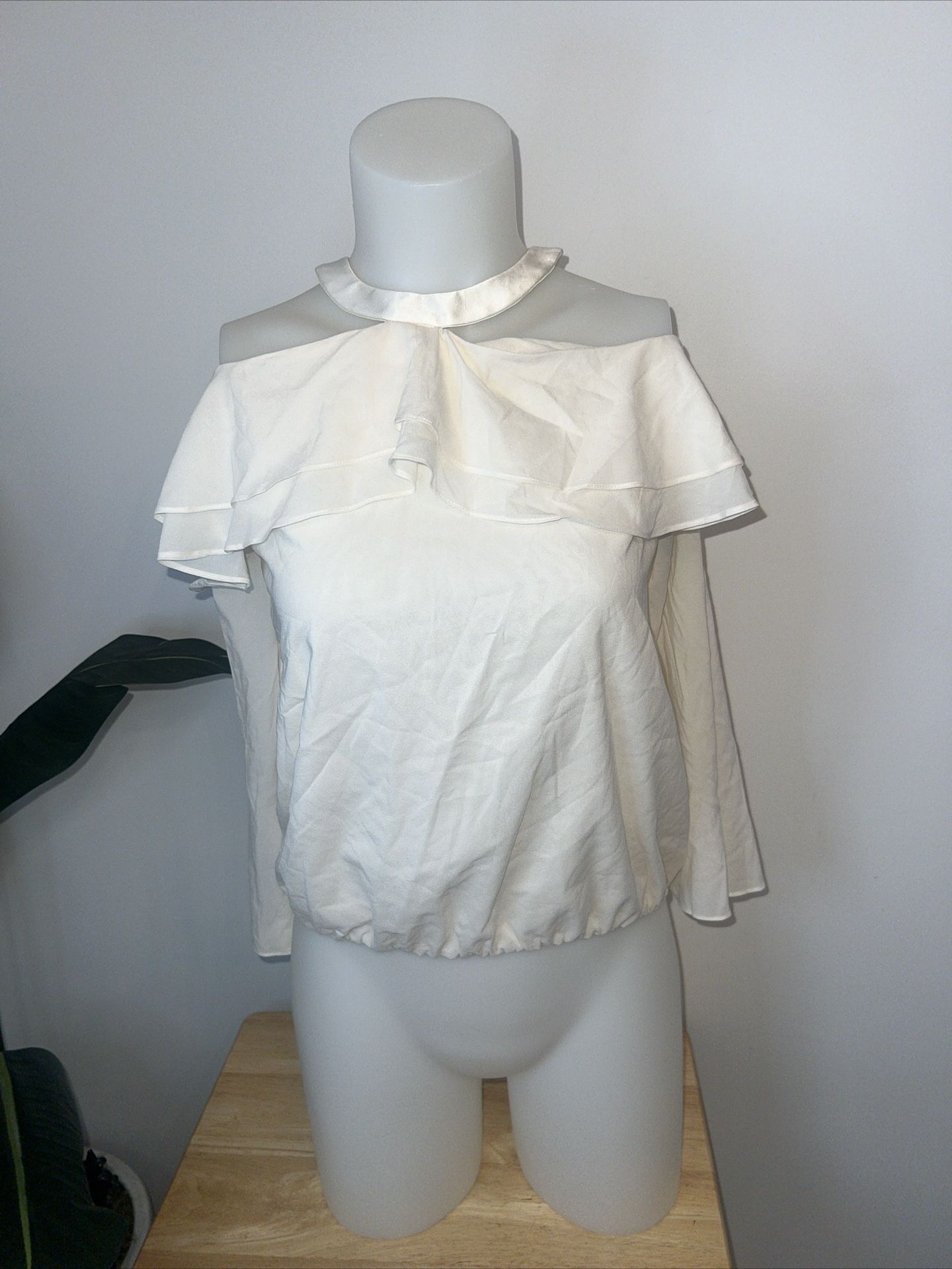 Alice + Olivia "Layla" ruffle blouse. High, halter neckline; keyhole back. Ruffle overlay around top shoulders. Cold shoulders. Bracelet sleeves. Rela