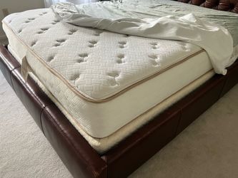 Queen sized mattress, box spring and brown leather upholstered Queen bed frame
