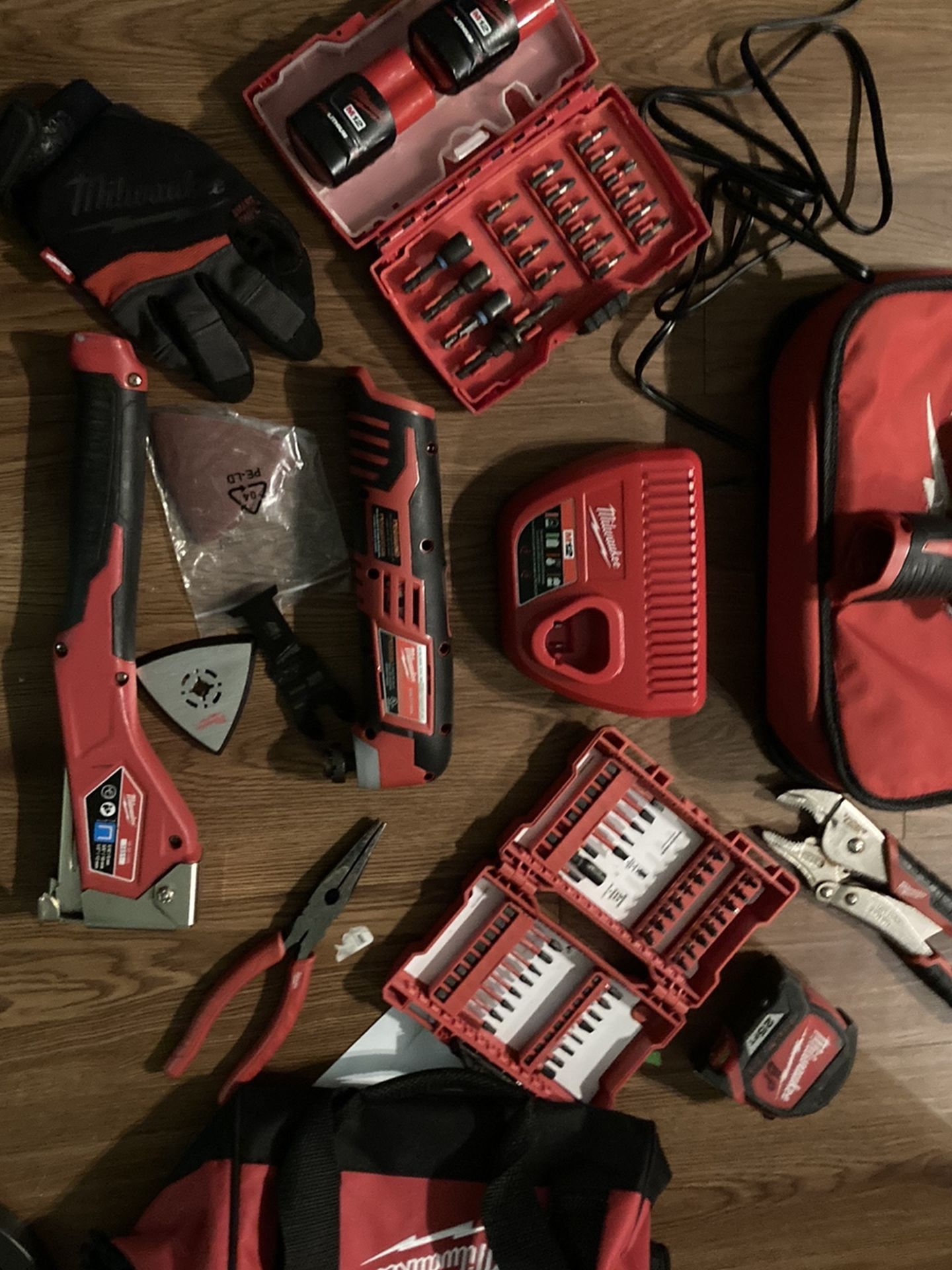 Milwaukee Drill/ Driver, Multi Tool , Stapler,2 M12 Battiers, 1 Charging Station 1 Vice Grip 1 25ft Tape 1 Needle Nose Pliers, 2 Case Of Shock Wave