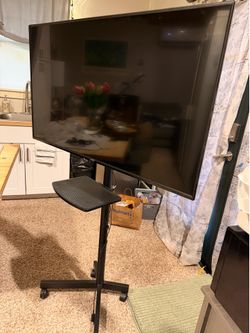 50”Smart TV.  New condition. Comes with adjustable tilt/swivel stand with adjustable shelf.