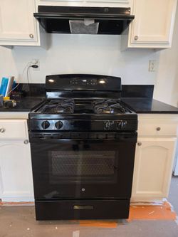 Stove plus stove hood all black.