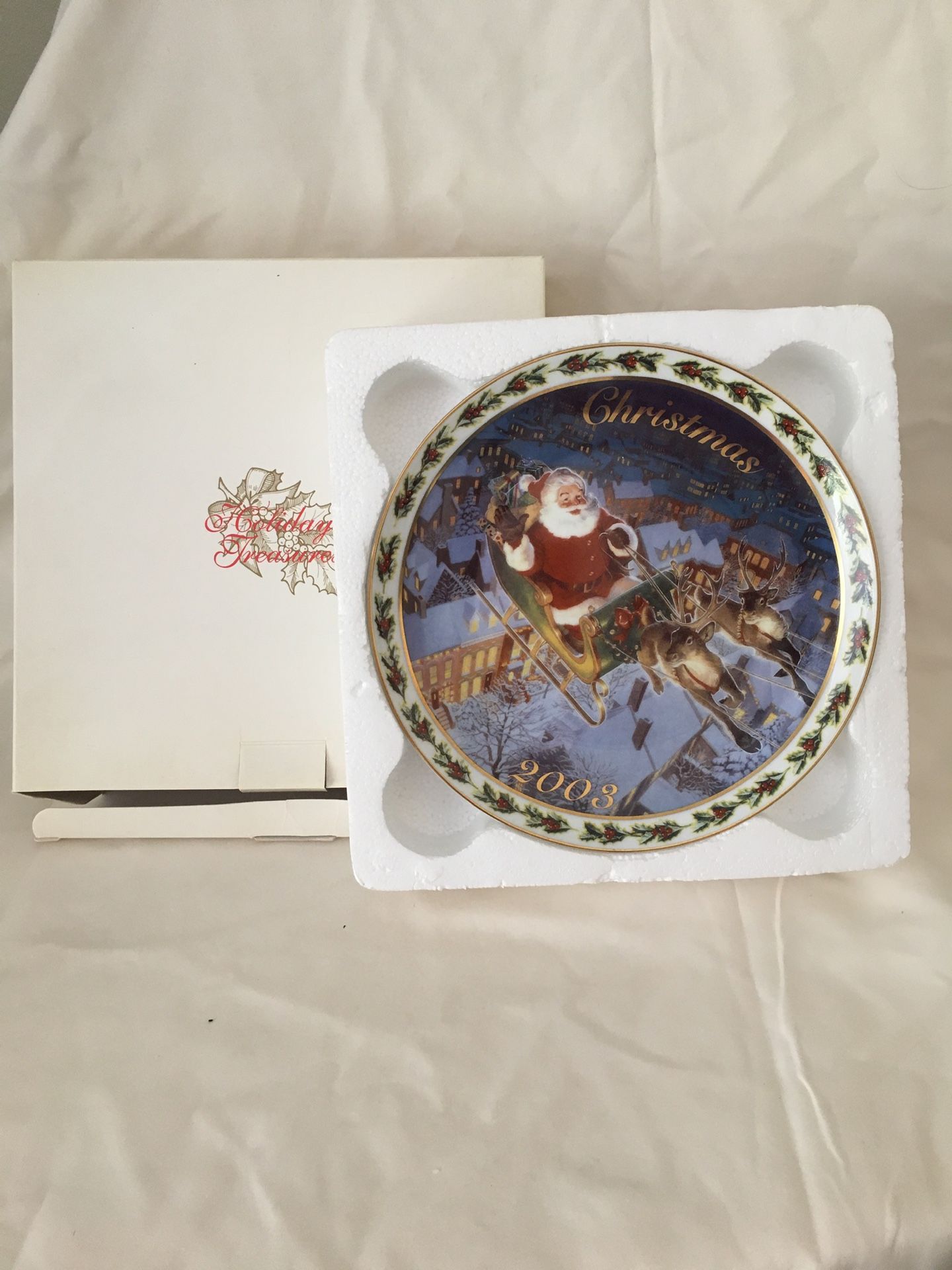 2003 Avon Christmas plate/ and 1999 Avon Christmas plate.