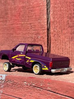 Revell Lowriders diecast model of a 1990 Chevy S-10 pickup in purple.