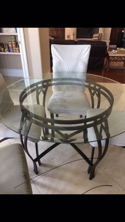 Dinnette set Glass table 4 chairs and a bakers rack. (Bakers Rack not pictured)
