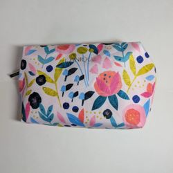 New Clinique cosmetic bag features a vibrant multicolor floral pattern and a zipper closure