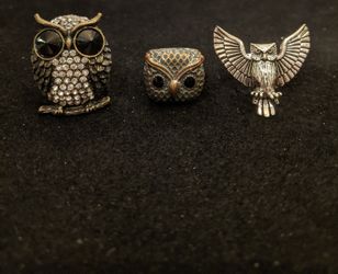 $15. Three owl rings. The ring with the wings spread size 8.5. The copper colored ring is size 5.5. The rhinestone ring is a stretch ring.