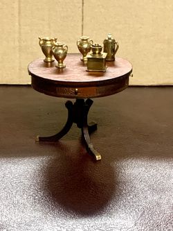 Beautiful finish on this table. 3 3/4" in diameter and miniature accessories 