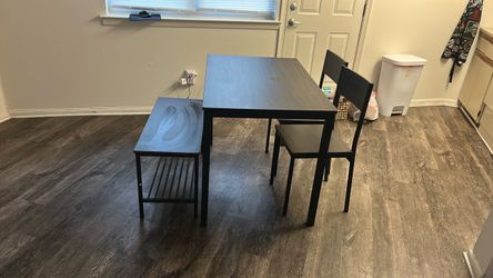 Dinner table with two chairs and bench