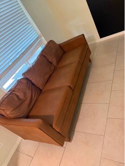 2 identical brown couches