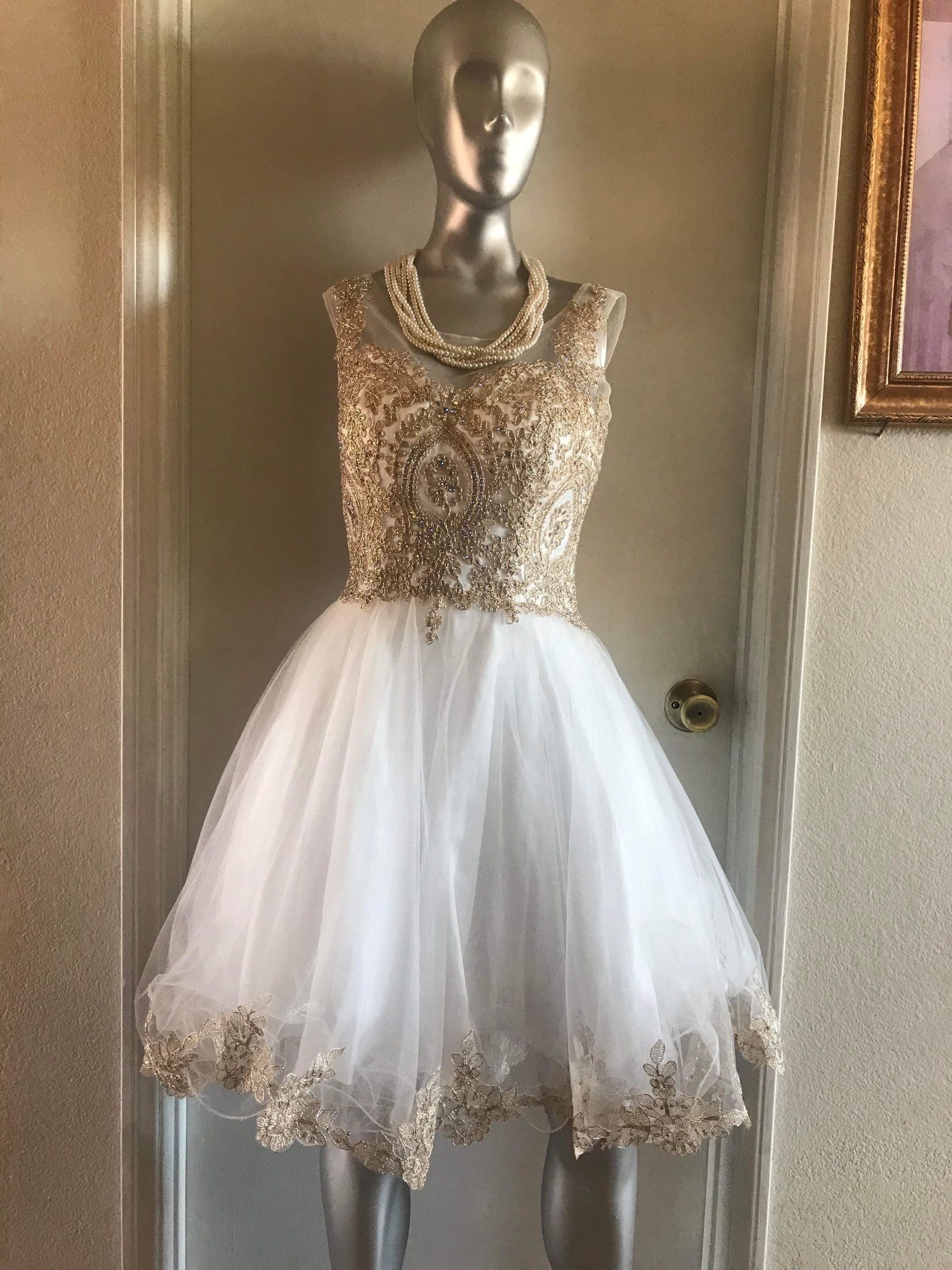 Woman’s Gold And White Dress