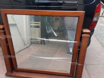 Beveled mirror on wooden frame