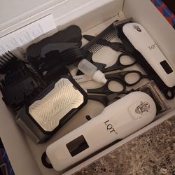 Barber machines and alcohol and a mirror and cape