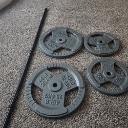 Weight plates and bar.  1" hole