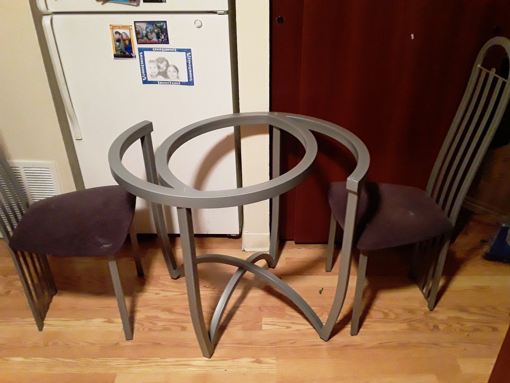 Metal table base and two chairs