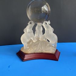 Three Glass Elephants Holding A Crystal Ball