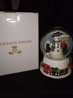 The Mackenzie-Childs Greeter Snowman 2023 Musical Snow Globe