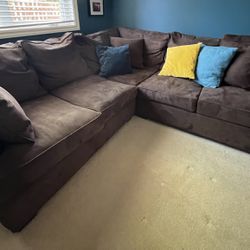 Brown sectional couch and pillows