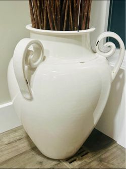 Huge ceramic vase with tall natural twigs.